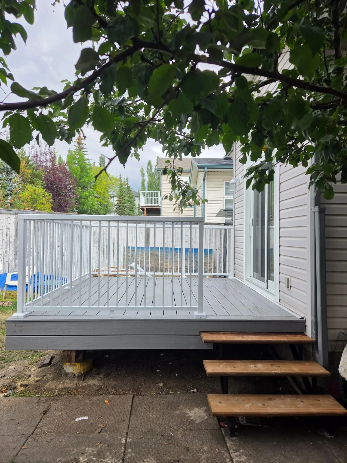 Finished grey deck and white railings in Calgary